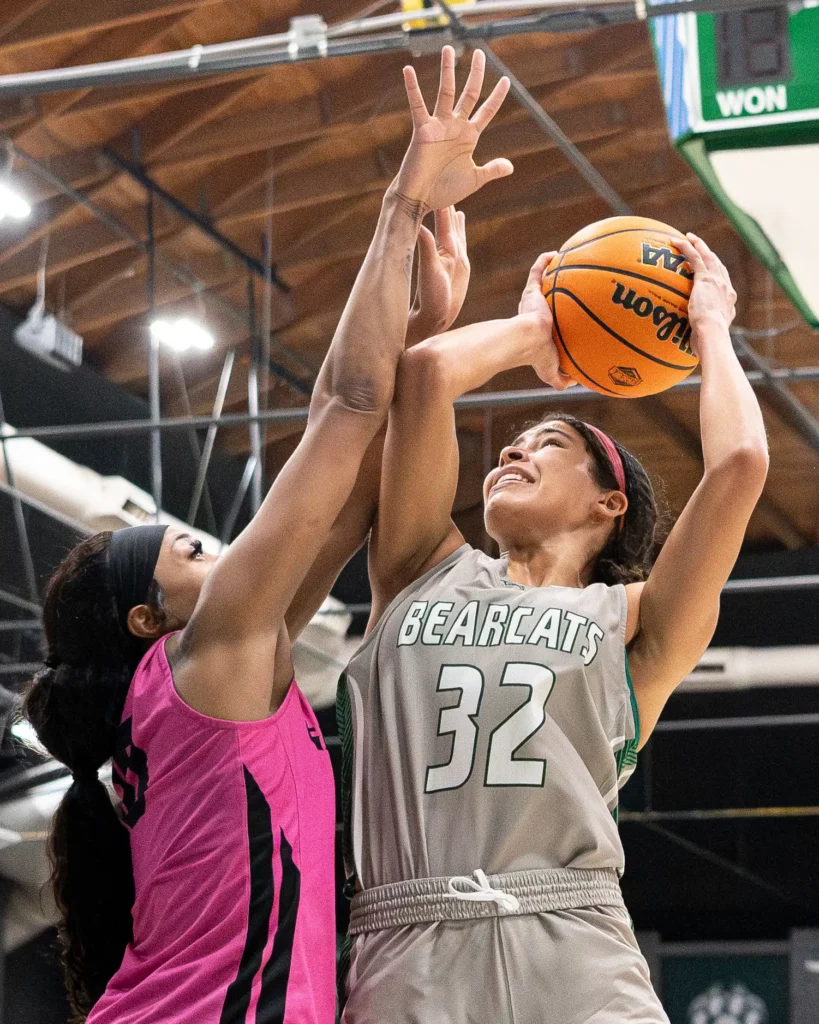 Bearcat women's basketball forward Jayna Green goes for a shot as the defense blocks her.