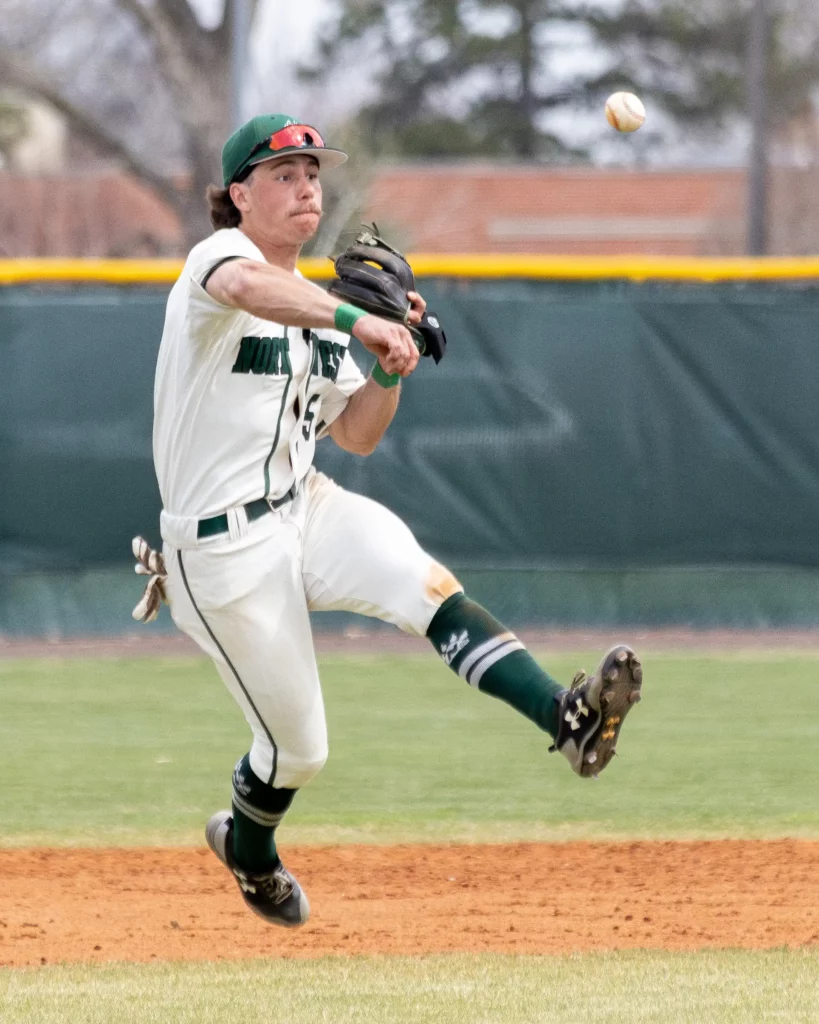 Bearcat baseball infielder Jacob Selock throws the ball to first base.