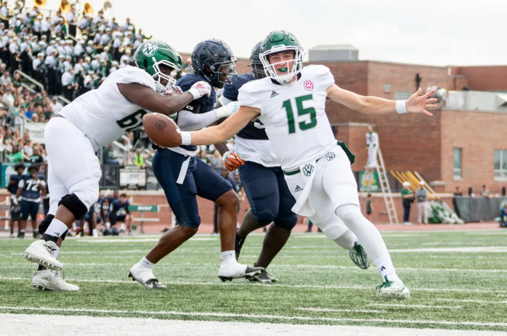 Bearcat football quarterback Chris Ruhnke celebrates as he scores a touchdown.