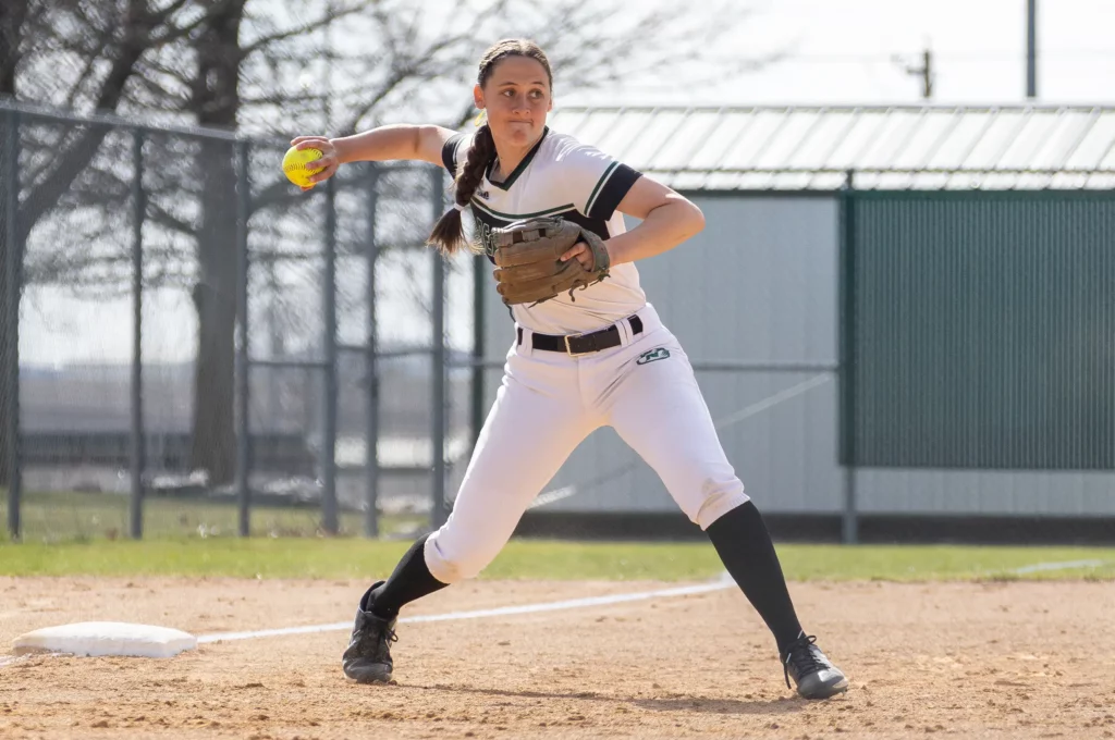 Bearcat softball infielder Lela Bryant throws the ball to first base.