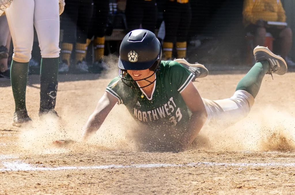 Bearcat softball infielder Annie Gahan slides into home base.