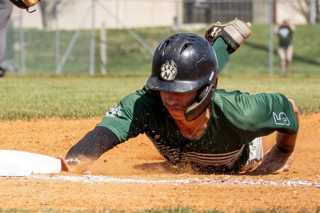 Bearcat baseball infielder Jacob Selock slides into first base during a loss against Newman.