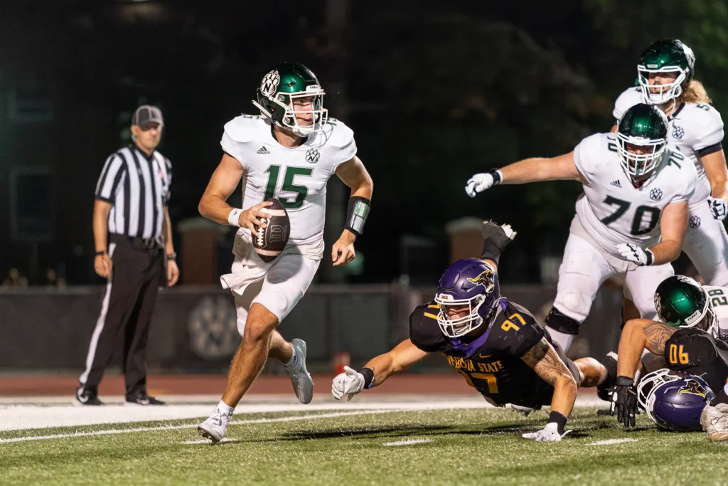 Bearcat football quarterback Chris Ruhnke breaks a tackle while searching for an open teammate.